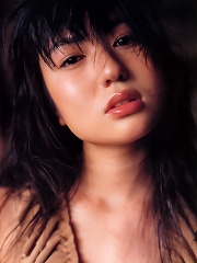 Beautiful sultry asian model tantilizes in her skimpy bikini